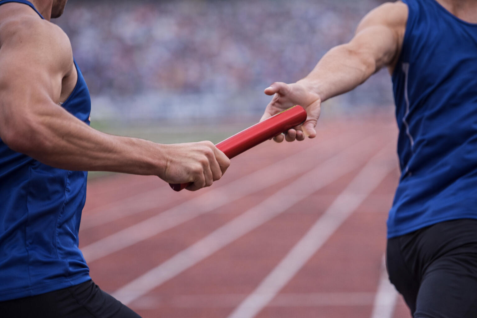 Relay race baton handoff symbolizing stepping into leadership responsibility during a transition period