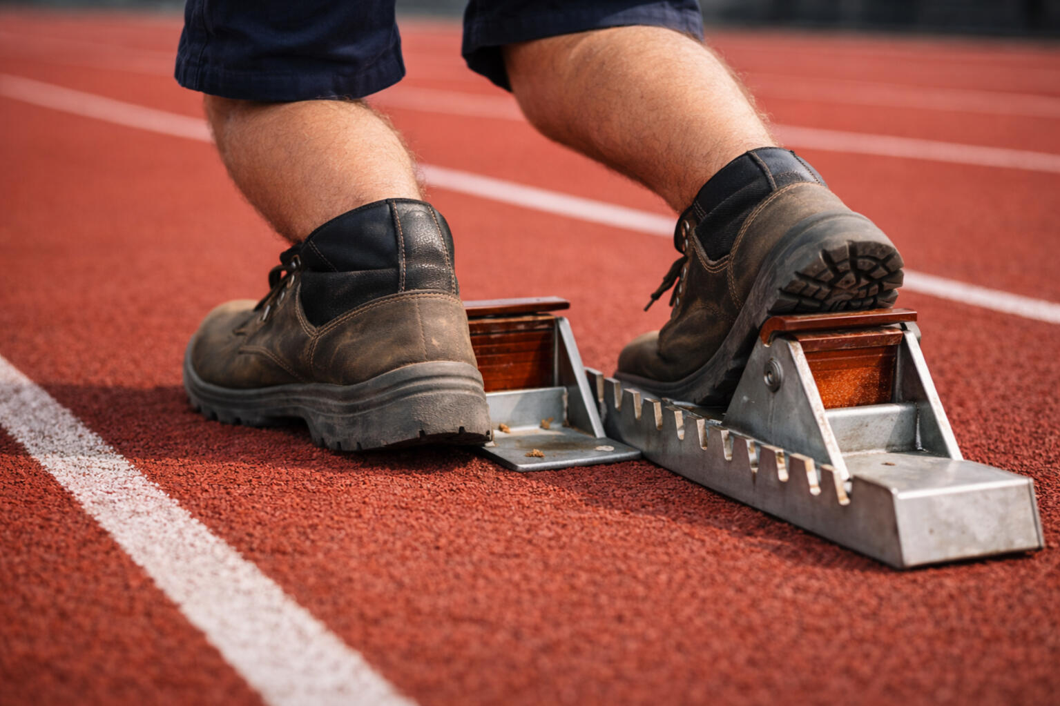 Runner launching from a starting block symbolizing a focused sprint to rebuild a business workflow
